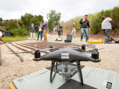 a picture of a drone with group of people in the background